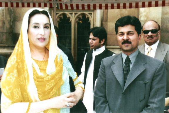 Muhammad Farhan Aslam is standing with the late former Prime Minister of Pakistan, Benazir Bhutto, at the House of Lords in London.