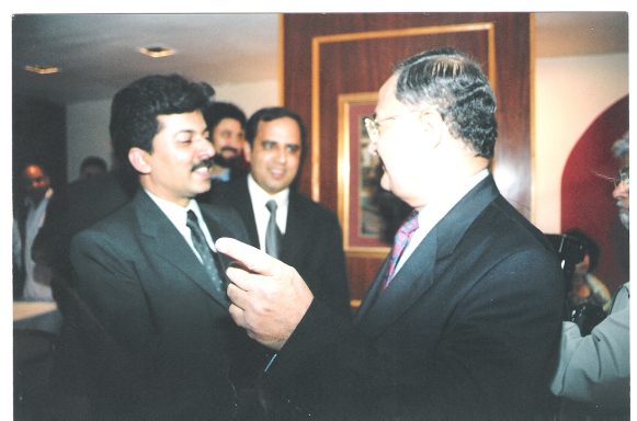 Muhammad Farhan Aslam, Editor of Daily Ausaf London, shaking hands and speaking with Pakistan Federal Information Minister Nisar Memon.